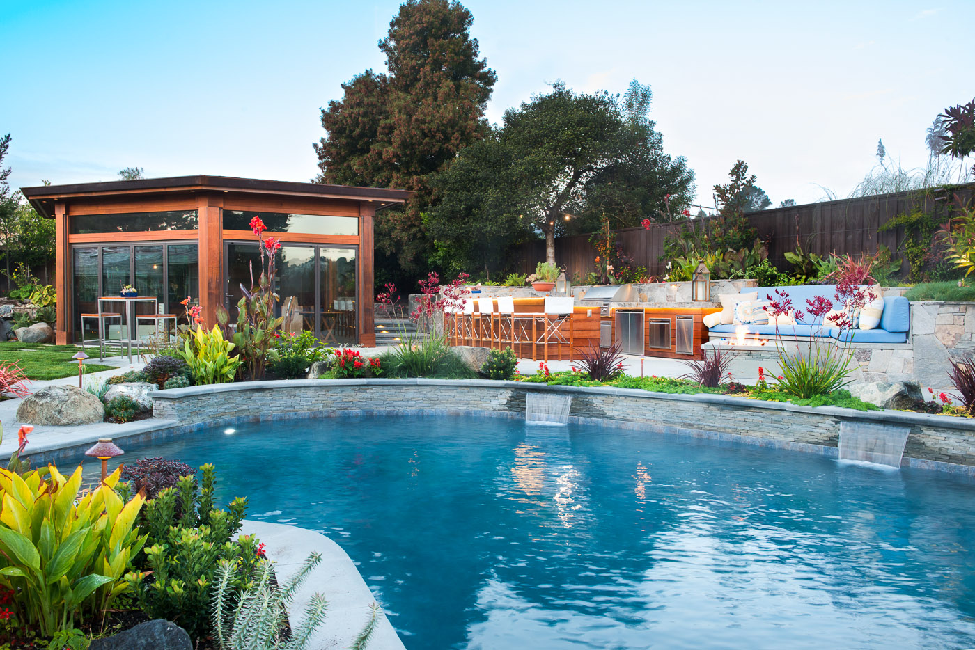 Pristine poolscape, outdoor kitchen, and luxury pool house